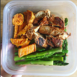 tupperware with bbq chicken, sweet poatoes and asparagus