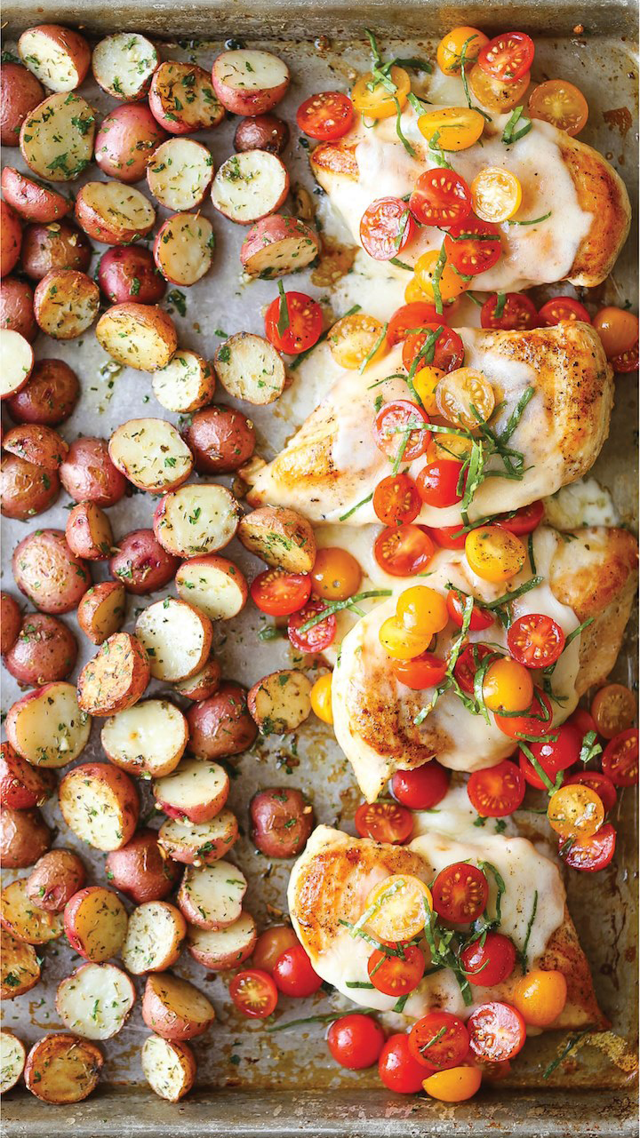 Sheet-Pan Bruschetta Chicken from Damn Delicious featuring mini red potatoes sliced in half and four chicken breast
