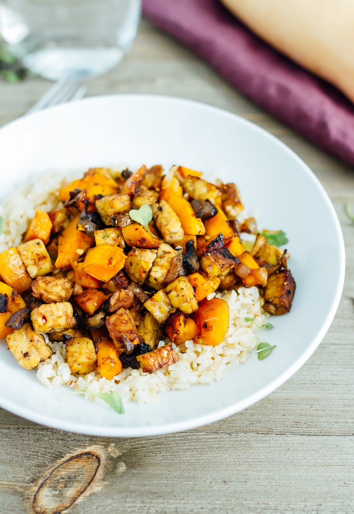 Tempeh and Butternut Squash Bake featuring tempeh and rice in a white bowl one-pan dinner idea