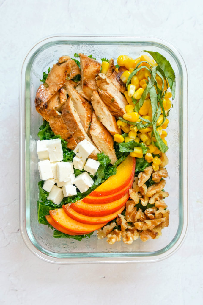Basil Lime Chicken & Peach Salad in a meal prep container, perfect for a picnic.
