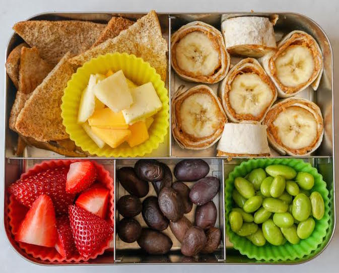 A snack box with different types of food that is perfect for a picnic