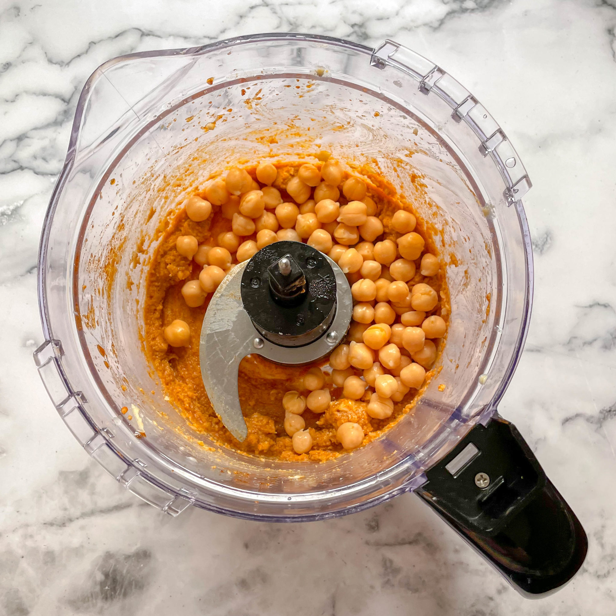 Ingredients in a blender making a homemade hummus recipe