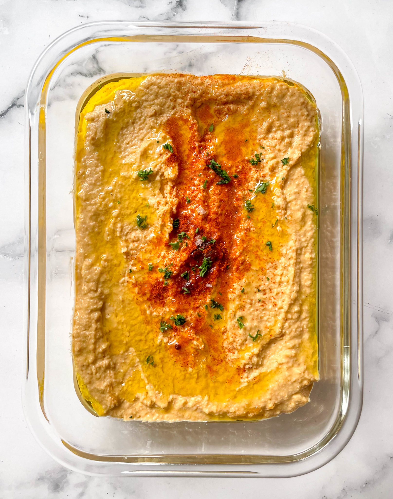 Homemade hummus in a rectangular meal prep container