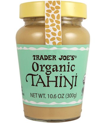 A jar of tan tahini with a blue label from Trader Joe's 