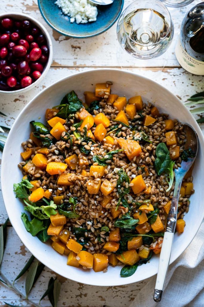 https://workweeklunch.com/wp-content/uploads/2021/07/Roasted-Butternut-Squash-Salad-with-Kale-Farro-and-Cranberry-Dressing-kitchenconfidante.com-3190-1-683x1024.jpg