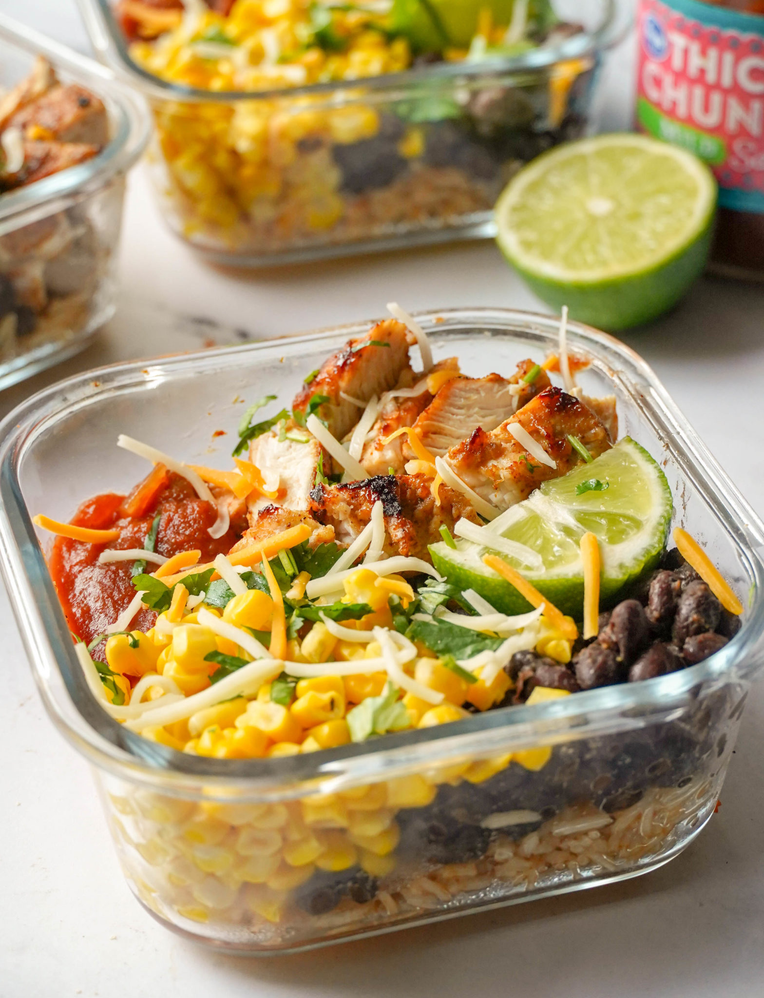 mixed hispanic veggies, rice, and chicken in a glass bowl