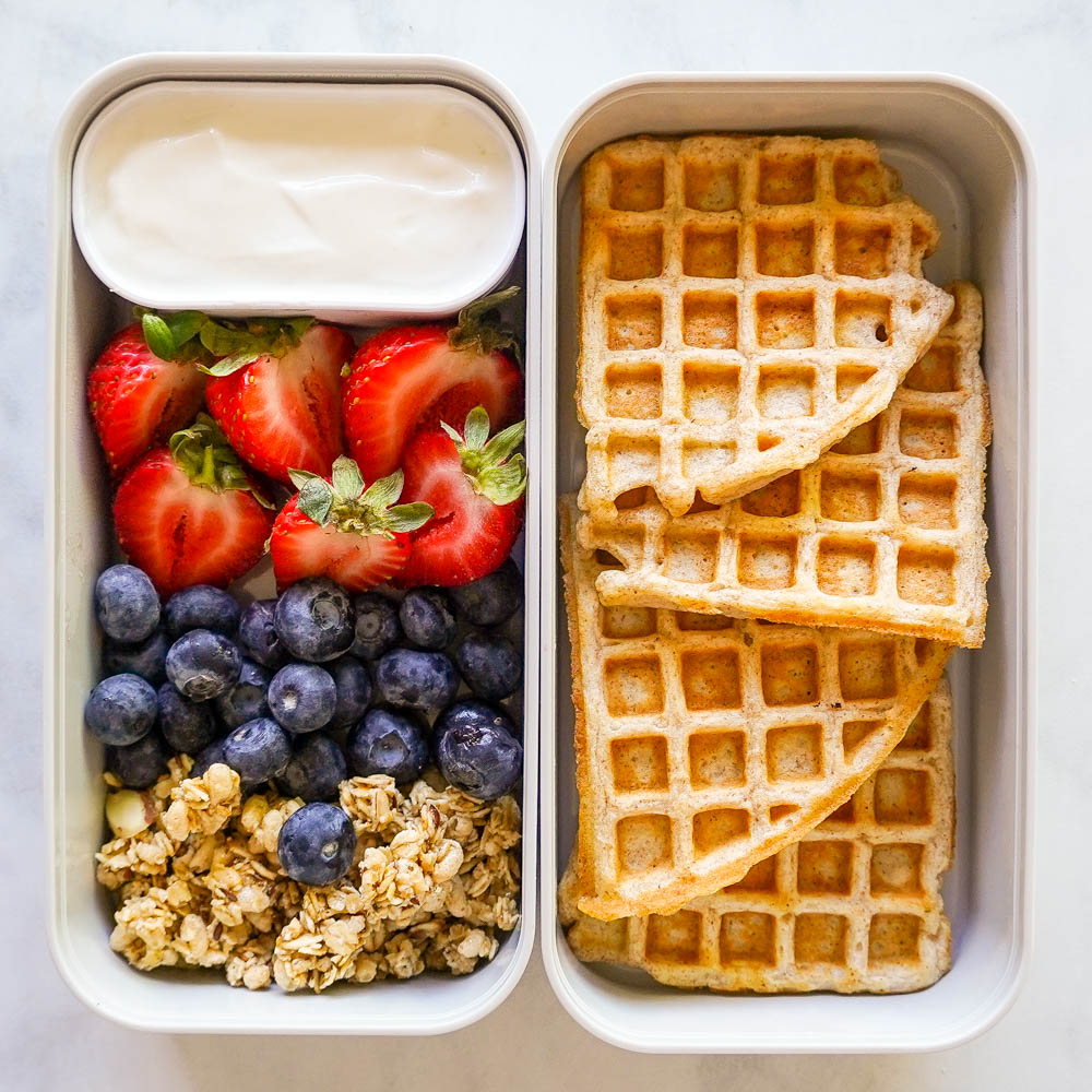 waffles and berries with yogurt in meal prep containers