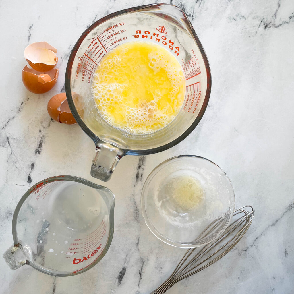 butter and eggs mixed together in a measuring glass